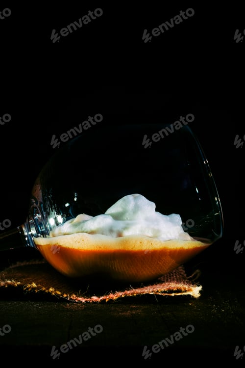 Preview: Coffee with milk foam inside a glass of ball.