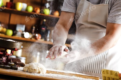 Preview: Close up of male baker hands kneading dough.