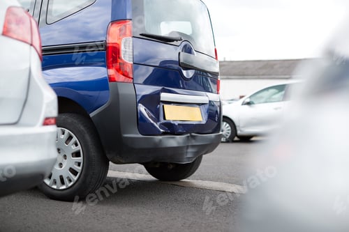 Preview: Detail Of Damage To Rear Bumper Of Vehicle In Car Park