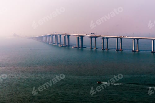 Preview: Boat sailing in the open sea with a bridge on the background