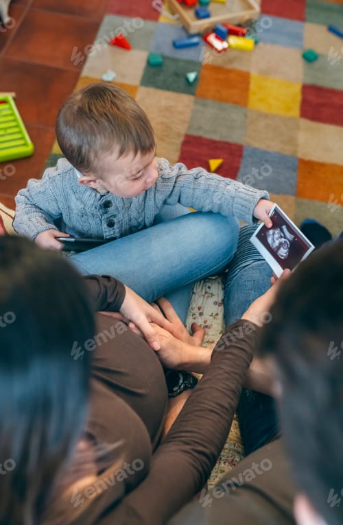 Preview: Parents looking ultrasound of their new baby