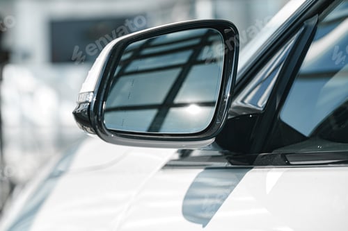 Preview: Mirror of a new white luxury car