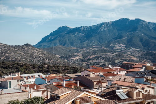 Preview: Quaint town nestled in the mountains with a clear blue sky
