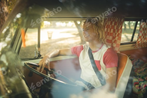Preview: Smiling man sitting in camper van