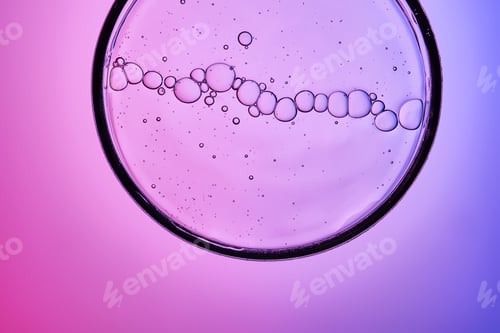 Preview: Serum with bubbles in a petri dish on a purple background.