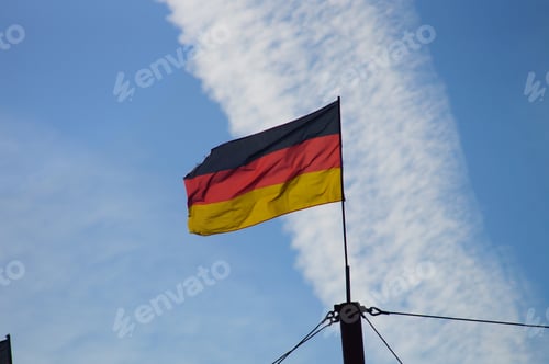 Preview: Germany flag waving in front of a contrail
