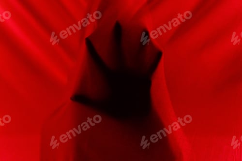 Preview: Faceless person hiding behind curtains at night time