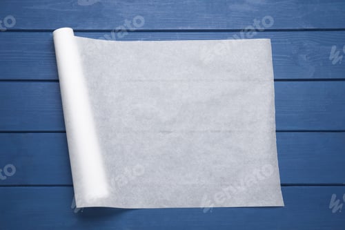 Preview: Roll of baking paper on blue wooden table, top view