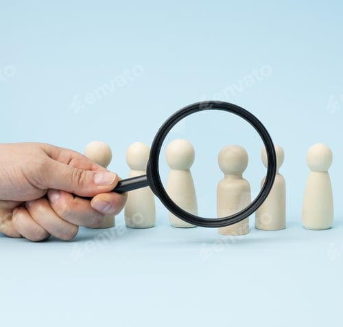 Preview: Wooden figures of men stand on a blue background and a black magnifying glass