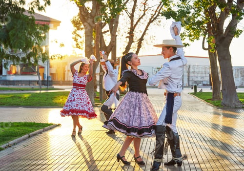 Preview: Latin American couples of huaso dancing cueca in the town square at sunset