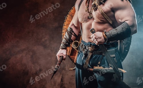 Preview: Powerful and muscular viking holding hatchet and knife