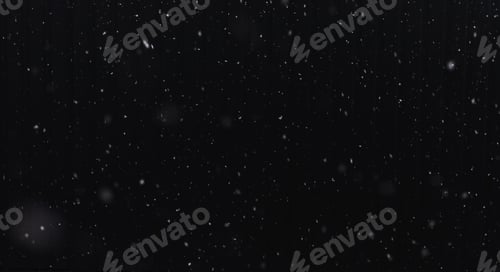 Preview: Falling snow on a black background. Selective focus.