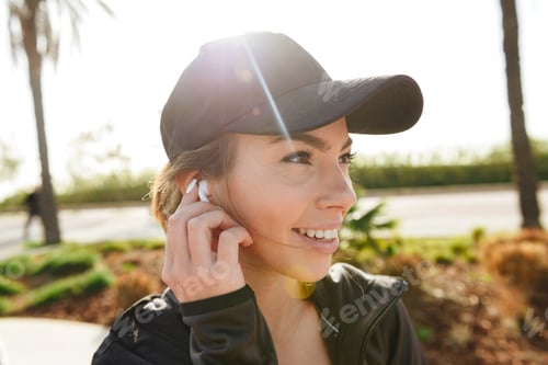 Preview: Beautiful young sports lady outdoors in park