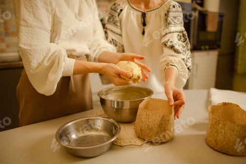 Preview: Ukrainian women cooking Easter cake at home, wearing traditional clothes vyshyvanka