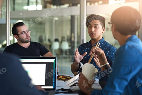 Preview: Shot of a group of colleagues eating while having a meeting in the boardroom