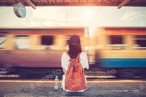 Preview: Traveler woman walking and waits train on railway platform