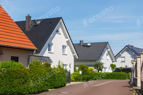 Preview: City street of single-family modern houses Germany against blue sky. German suburban small town