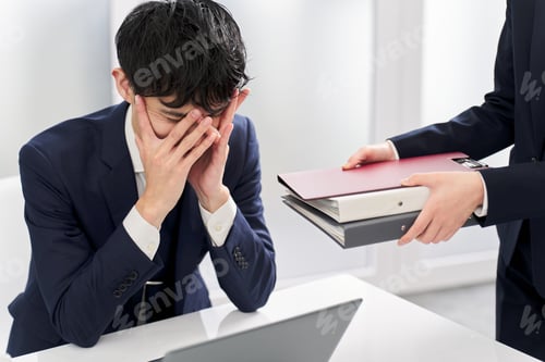 Preview: Asian businessman overwhelmed by workload