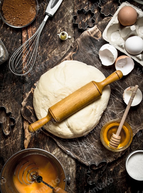 Preview: Dough background. Fresh dough with various ingredients on a wooden table.