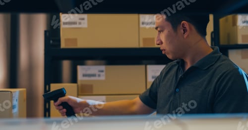 Preview: Asian man use barcode scanner scan box in shelf and put data in digital tablet cut stock online.
