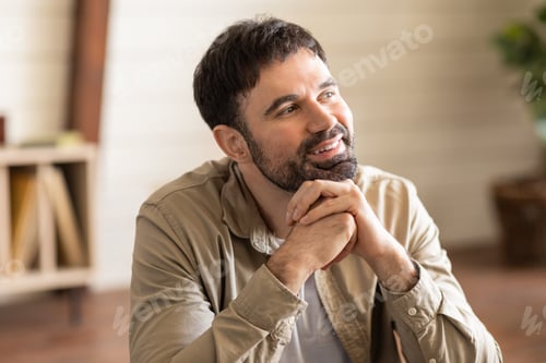 Preview: Man Sitting at Table With Folded Hands