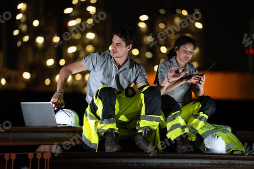 Preview: Engineer team sit for taking a break, talking with colleauge at night