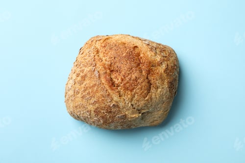 Preview: Fresh baked bun on blue background, close up