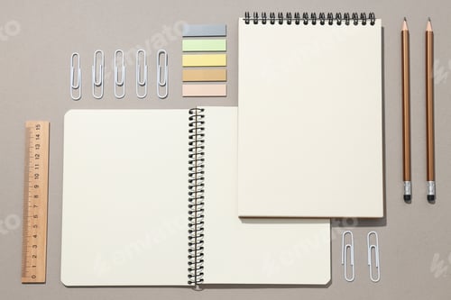 Preview: Open notebooks with stationery on a gray background