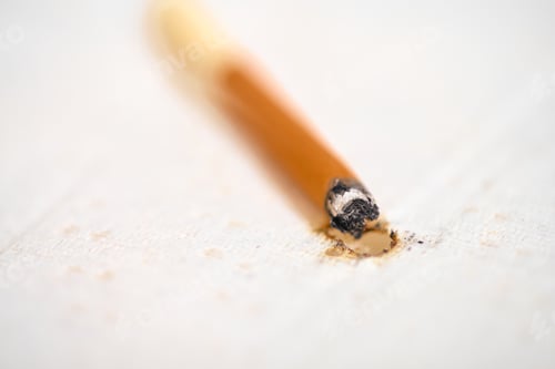 Preview: Cigarette burn on fabric surface in soft light