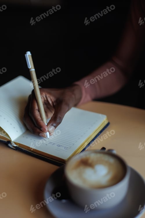 Preview: Cropped photo of African-American woman sitting at table with cup of coffee, glasses in cafe, taking