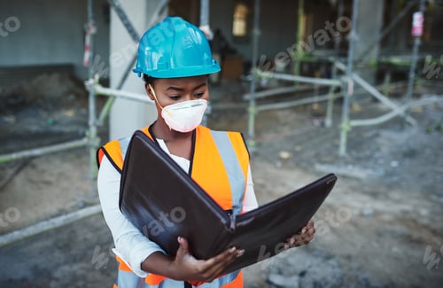 Preview: Plan well, build well. Shot of a young woman going over building plans at a construction site.