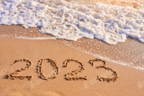 Preview: 2023 year written on sandy beach sea at sunny day
