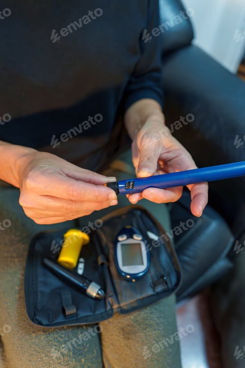 Preview: Elderly woman demonstrating diabetes self care by using an insulin pen