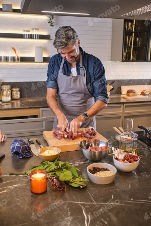 Preview: Man in apron cooking in kitchen