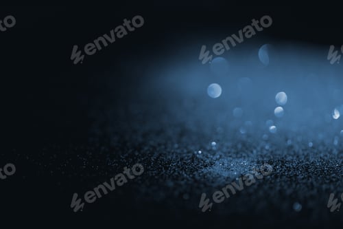 Preview: blurred blue glitter on dark background