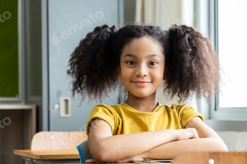 Preview: an African American student girl in the classroom. She smiled happily. Back to school concept