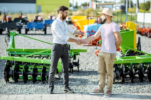 Preview: Agronomist with salesman at the shop with agricultural machinery