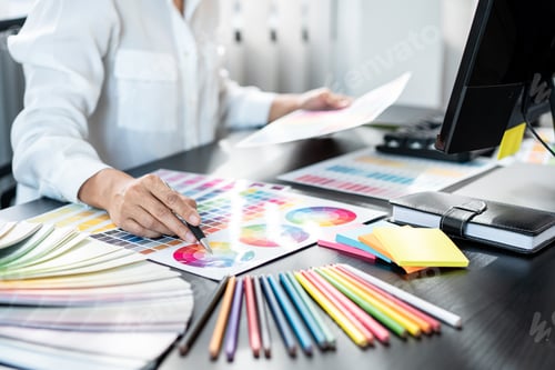 Preview: Young creative graphic designer working on color selection and drawing on graphics tablet