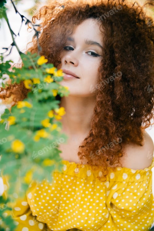 Preview: Smiling Woman Posing Outdoors in a Yellow Dress
