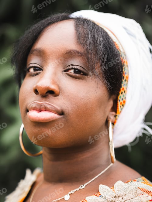 Preview: Dreamy black woman in traditional outfit in garden
