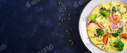 Preview: Omelette with broccoli, tomatoes and red onions on dark table