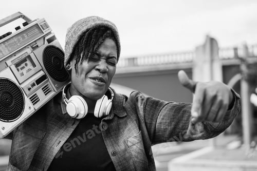 Preview: African american woman listening music from vintage boombox stereo