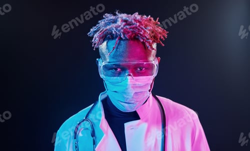 Preview: Futuristic neon lighting. Young african american man in the studio