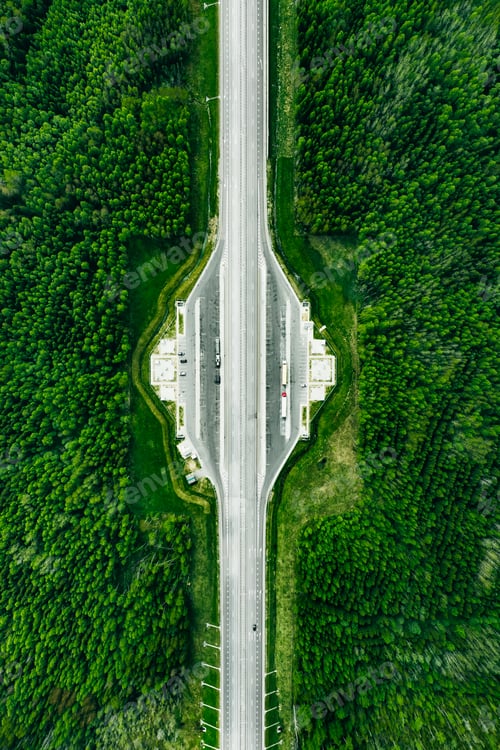 Preview: Aerial view of Toll Road Highway with parking in green Forest.