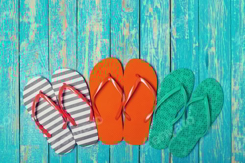 Preview: Colorful Flip Flops on a Weathered Blue Wood Surface