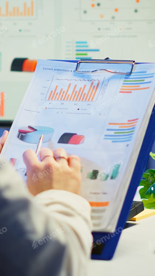 Preview: Close up of business woman holding clipboard with graphics