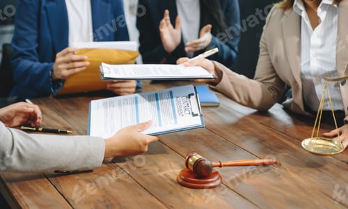 Preview: business people and lawyers discussing contract papers sitting at the table.