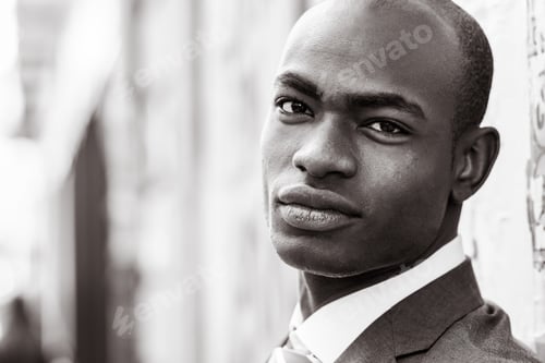 Preview: Handsome black man wearing suit in urban background