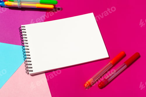 Preview: Brightly colored workspace with blank notepad and markers for creative projects