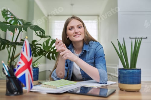 Preview: UK learning English online. Female student remotely looking at webcam